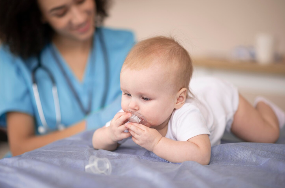 Baby using a nipple protector while a caregiver watches, highlighting baby essentials like nipple protector and nose aspirator.
