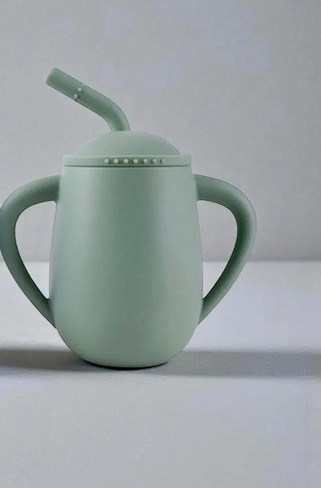 Giggle Bubs toddler silicone straw cup in soft green with easy-grip handles for kids.