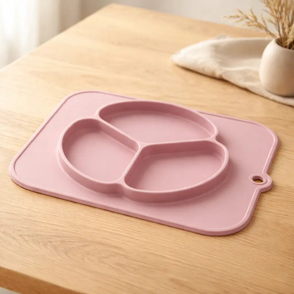 Baby silicone non-slip plate in pink color designed for mealtime ease and stability on dining surfaces.