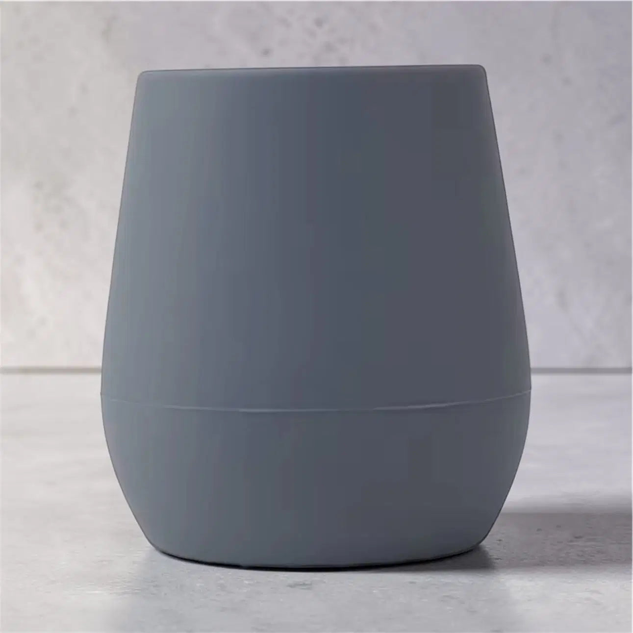Mini EzyPzy Cup in soft gray silicone for toddlers, designed for easy grip and independent drinking.