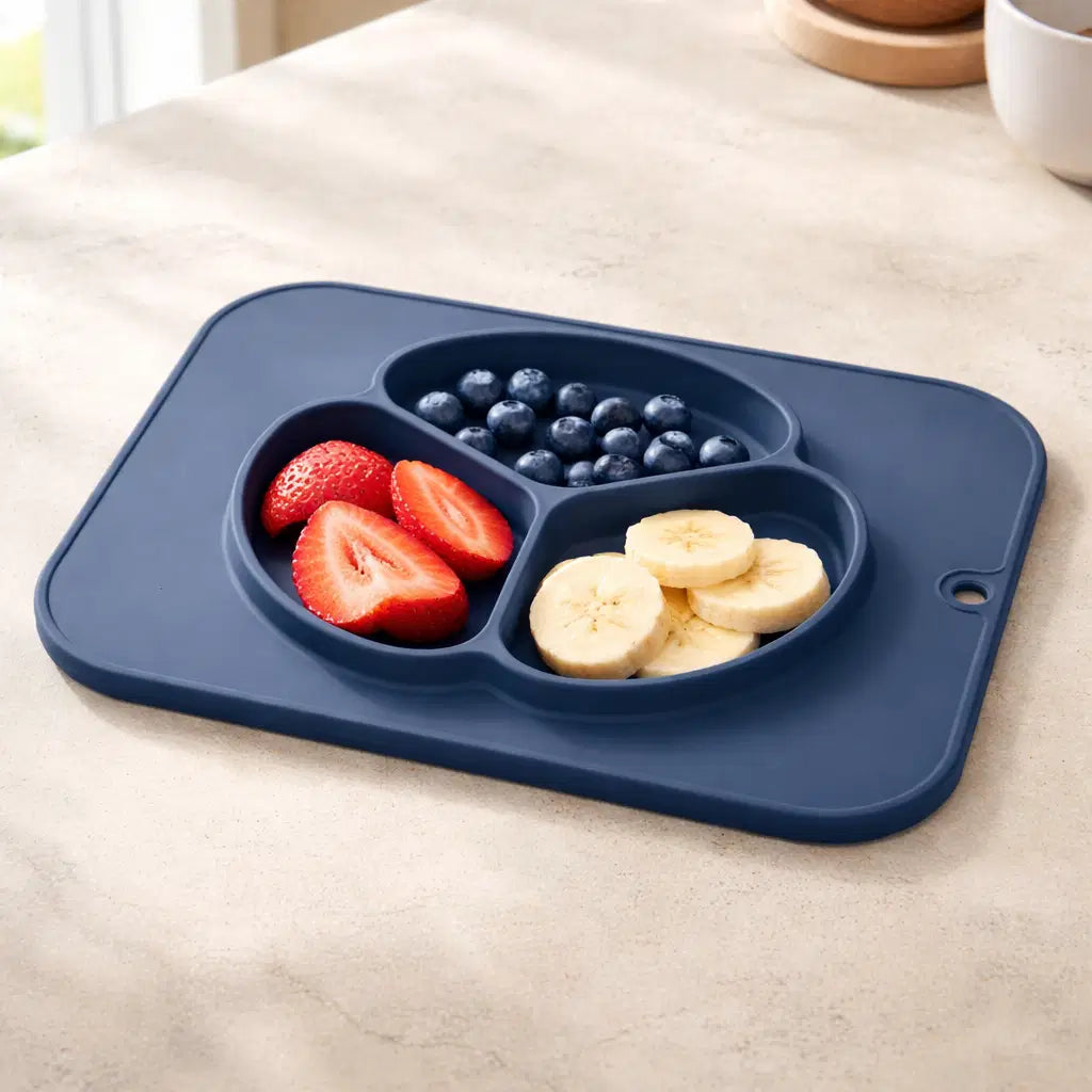 Giggle Bubs baby silicone non-slip plate with fruit compartments ready for mealtime.