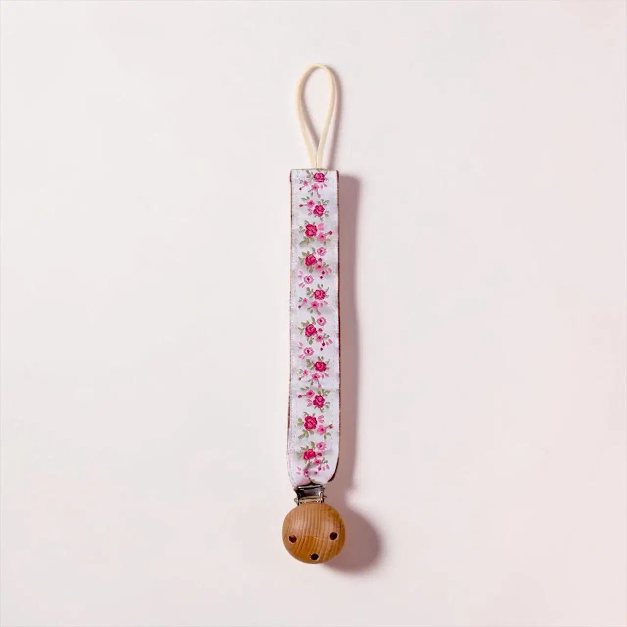 Giggle Bubs Luxe Dummy Clip, safe and stylish dummy clip for babies with floral design and natural wooden clip.