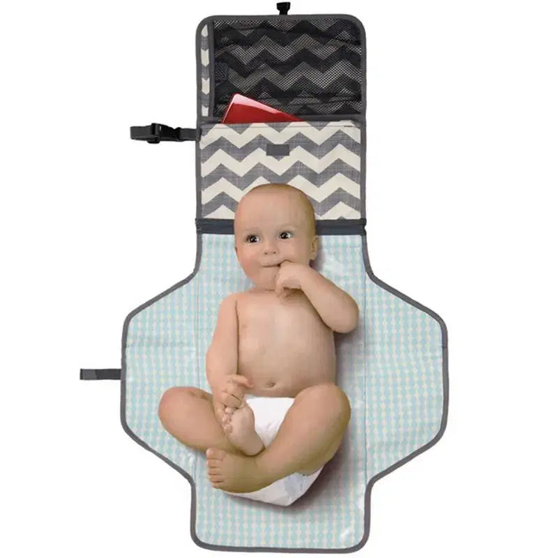 Skip Hop portable changing pad with storage pockets and chevron design.